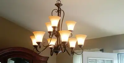 Classic ceiling chandelier installation with warm lighting in Sacramento, CA
