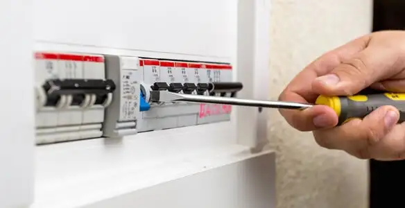 electrical panel upgrade service showing technician adjusting circuit breakers during system upgrade in Sacramento, CA