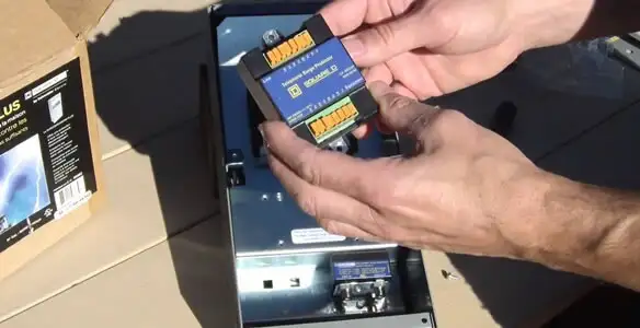Electrician installing whole home surge protection unit inside main electrical panel in Sacramento, CA