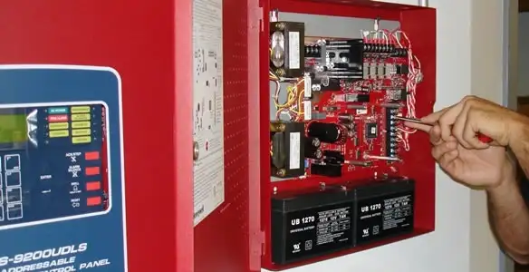 fire alarm installation service showing technician configuring fire alarm control panel in Sacramento, CA