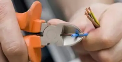 professional electrical services showing precise wire cutting by licensed electricians in Sacramento, CA
