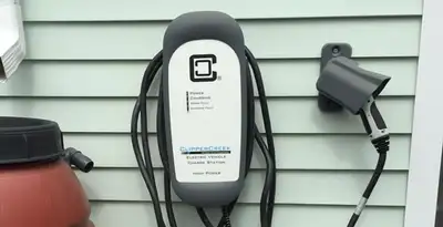 Outdoor electric vehicle charger installation on residential wall in Sacramento, CA
