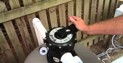 pool pumps service showing professional adjustment of pool pump control system in Sacramento, CA